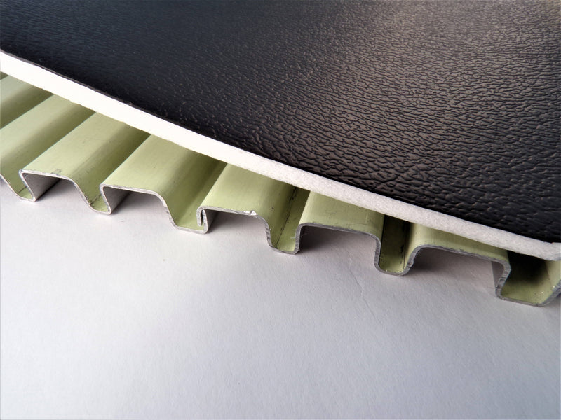 Pace Edwards JackRabbit: cut-away of green aluminum interlocking slats under a black textured vinyl overlay