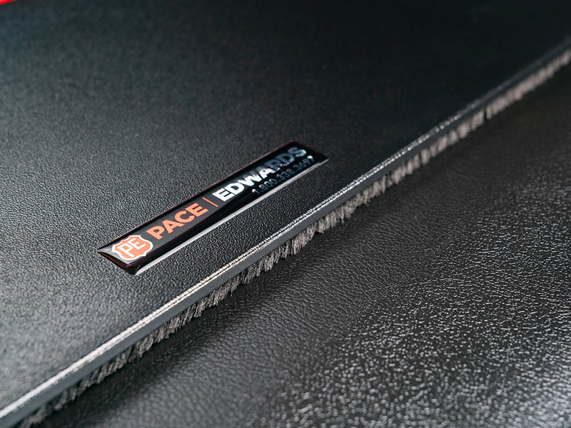Pace Edwards JackRabbit: Pace Edwards badge on the textured black vinyl surface of a cover slat