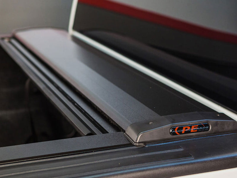 Pace Edwards SwitchBlade: close-up of the black retractable cover canister at the front of the bed, Pace Edwards PE end cap badge