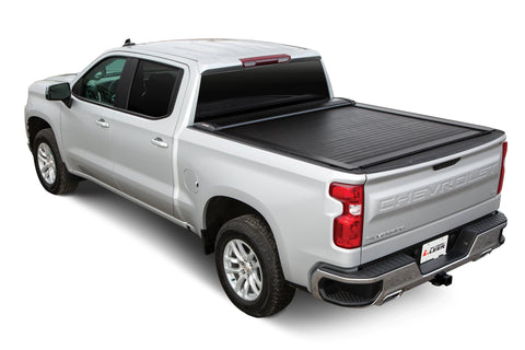 Pace Edwards SwitchBlade: silver pickup with a black retractable tonneau cover fully closed, rear three-quarter studio view