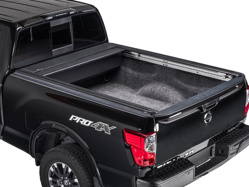 Pace Edwards UltraGroove Electric: cover fully retracted into its canister on a black pickup, open lined bed