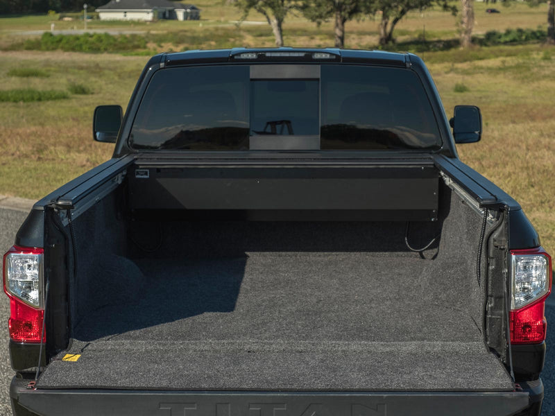 Pace Edwards UltraGroove Electric: cover fully retracted into its canister on a black pickup, tailgate down, lined bed