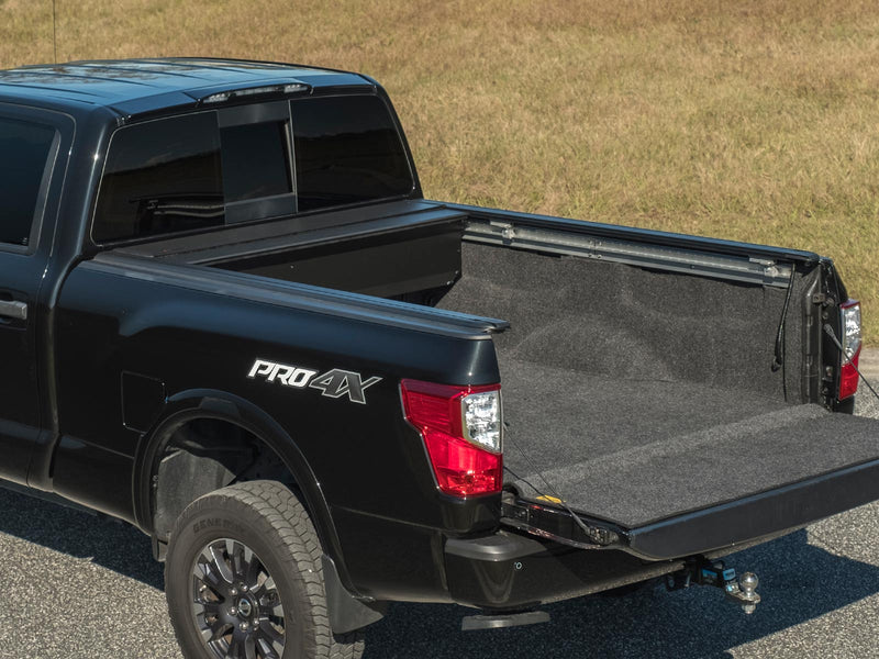 Pace Edwards UltraGroove Electric: cover fully retracted on a black pickup, tailgate down, lined bed exposed