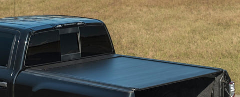 Pace Edwards UltraGroove Electric: matte black cover closed on a black pickup, tailgate down, rear three-quarter view