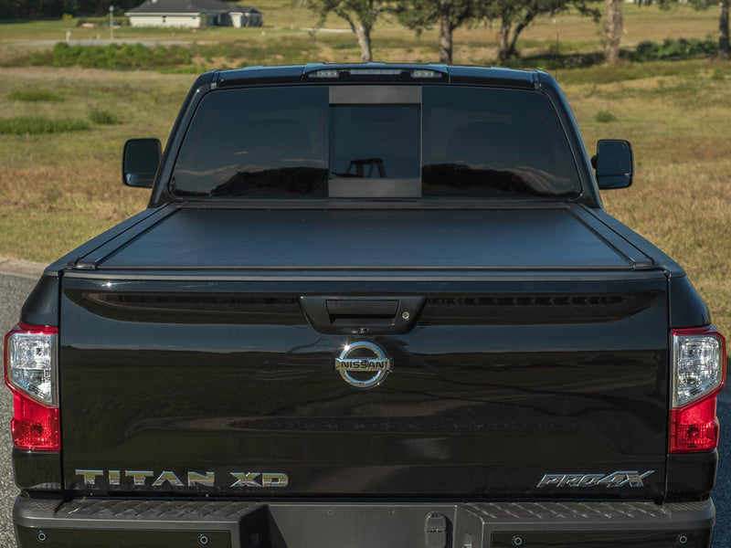 Pace Edwards UltraGroove Electric: matte black retractable cover closed on a black pickup, straight rear view