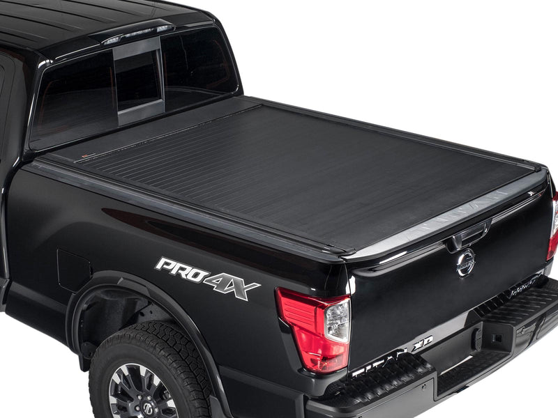 Pace Edwards UltraGroove Electric: matte black retractable cover fully closed on a black pickup, rear three-quarter view