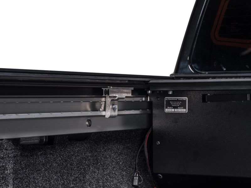 Pace Edwards UltraGroove Electric: side rail running into the black canister with its product label inside the bed