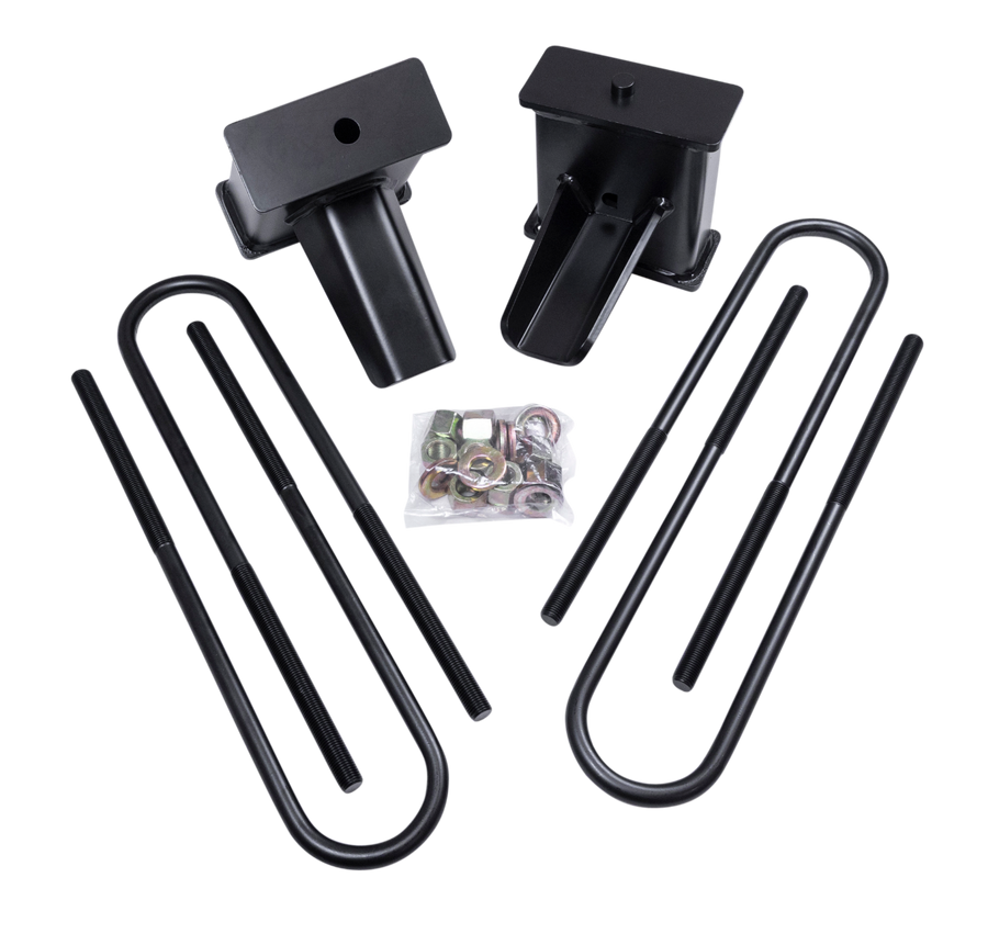 ReadyLIFT Block Kit, full kit on a studio background: two black 5" tapered rear lift blocks with four long black U-bolts and a bag of hardware on a black background