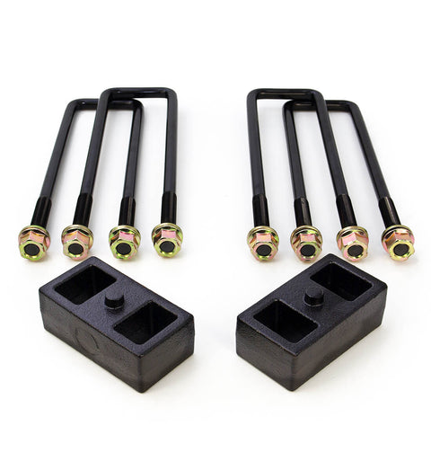 ReadyLIFT Block Kit, full kit on a studio background: two black cast rear lift blocks below four square U-bolts with gold nuts on white