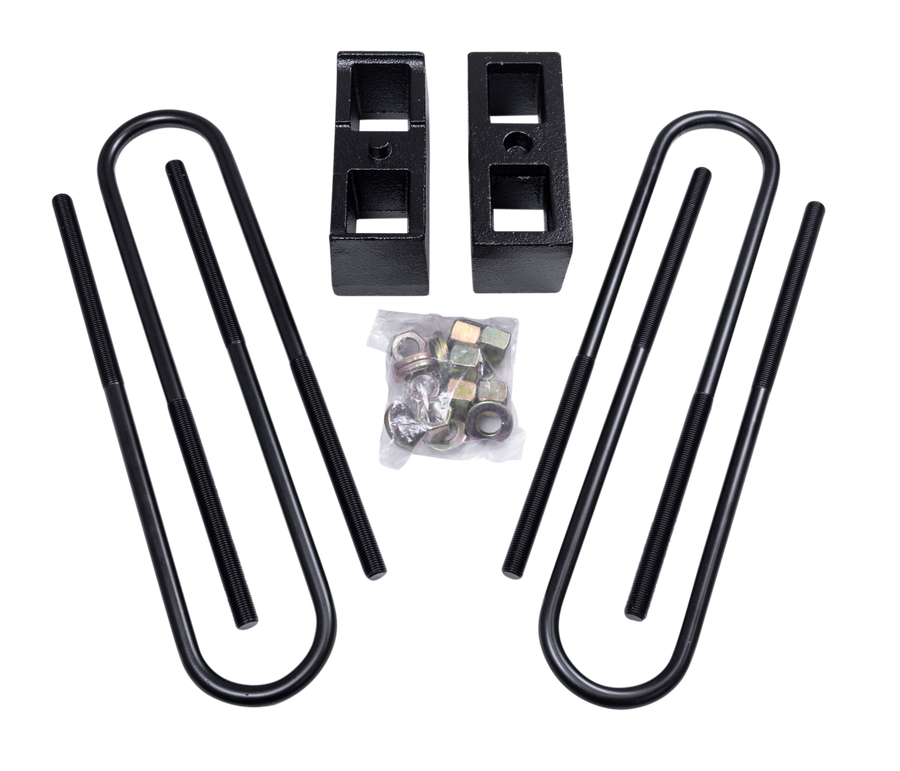 ReadyLIFT Block Kit, full kit on a studio background: two black rear blocks with U-bolts and bagged hardware on a black background