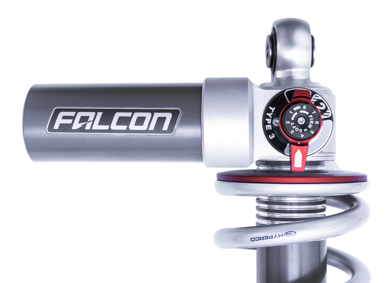 Close-up of the ReadyLIFT Coilover Front Lift Kit: close-up of a Falcon reservoir and Type 3 adjuster atop a coilover spring on black