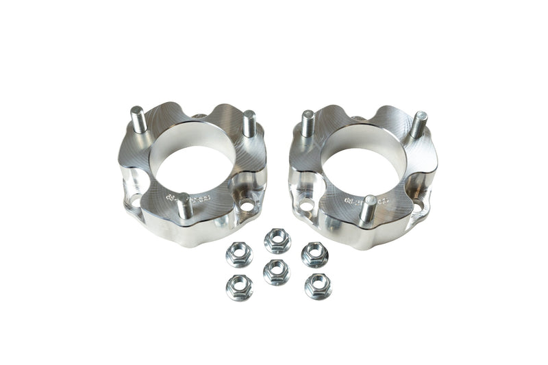ReadyLIFT Leveling Kit, full kit on a studio background: pair of aluminum strut spacers with studs and six flange nuts on white