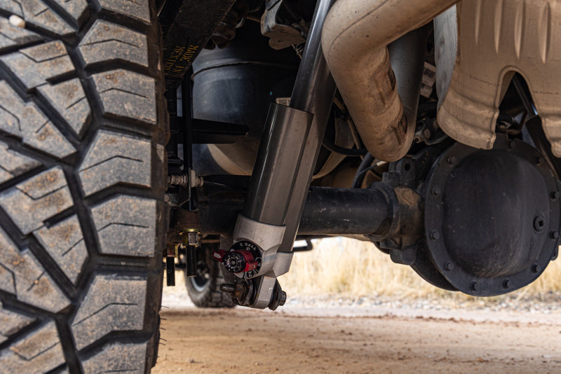 ReadyLIFT MAX3.3 Suspension System on a vehicle: Falcon rear shock installed beside the axle behind a mud tire, low angle