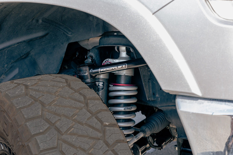 ReadyLIFT MAX3.3 Suspension System on a vehicle: ReadyLIFT upper arm and Falcon coilover visible in the front wheel well of a silver truck