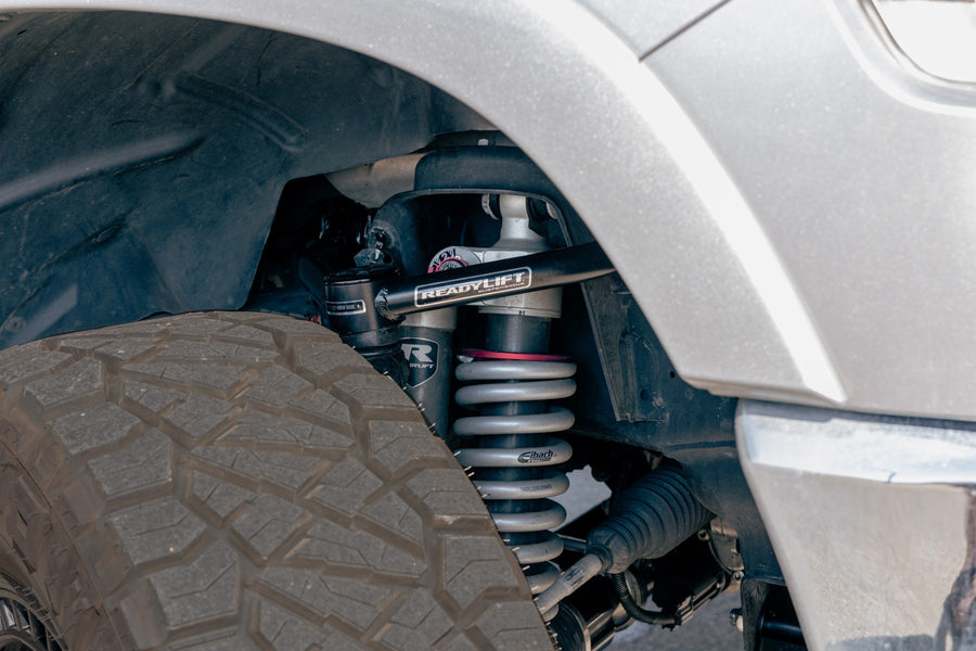 ReadyLIFT MAX3.3 Suspension System on a vehicle: ReadyLIFT upper arm and Falcon coilover visible in the front wheel well of a silver truck