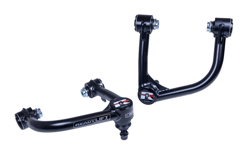 ReadyLIFT SST Lift Kit, full kit on a studio background: A pair of black tubular upper control arms with ball joints and ReadyLIFT lettering on white