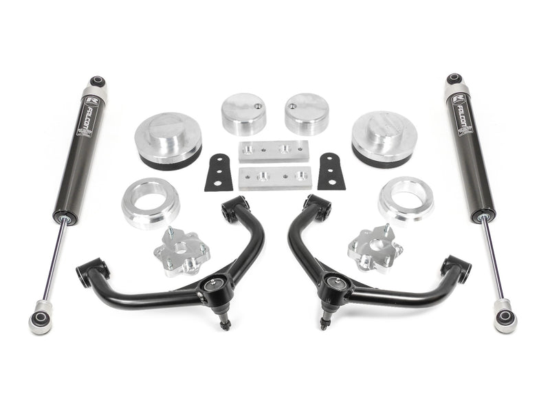 ReadyLIFT SST Lift Kit, full kit on a studio background: aluminum spacers, black upper control arms, brackets and two black Falcon monotube rear shocks on white
