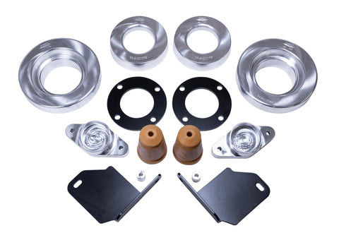 ReadyLIFT SST Lift Kit, full kit on a studio background: aluminum strut and coil spacers, black spacer plates, two bump stops and black brackets on white