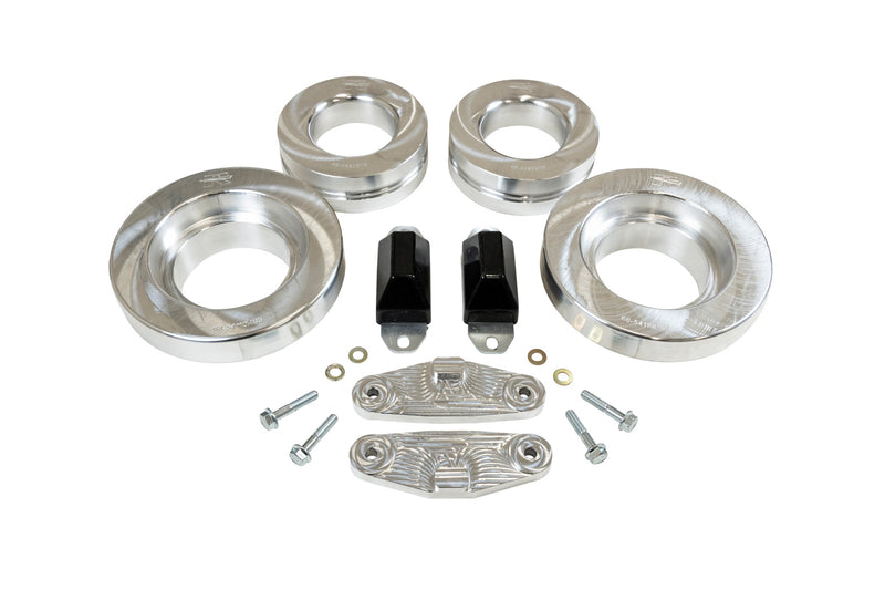 ReadyLIFT SST Lift Kit, full kit on a studio background: four aluminum coil spacers, two black bump stops, two aluminum brackets and bolts on white
