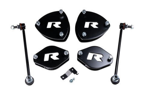 ReadyLIFT SST Lift Kit, full kit on a studio background: four black R strut spacers, two sway bar links and a small bracket on a black background