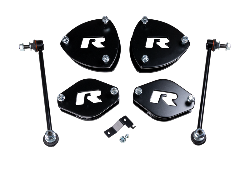 ReadyLIFT SST Lift Kit, full kit on a studio background: four black R strut spacers, two sway bar links and a small bracket on a black background