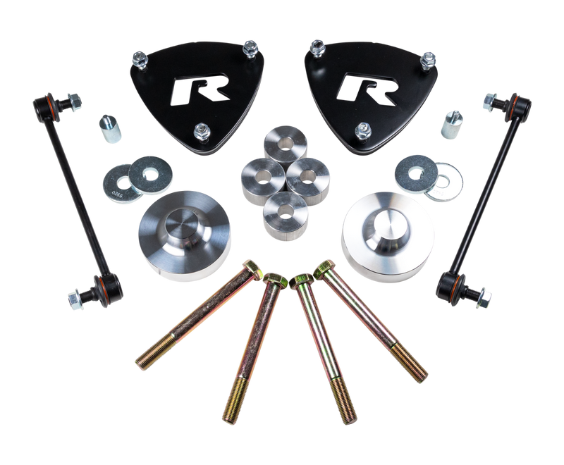 ReadyLIFT SST Lift Kit, full kit on a studio background: two black R strut spacers, aluminum rear spacers, sway bar links and long bolts on a black background