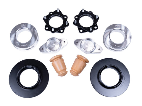ReadyLIFT SST Lift Kit, full kit on a studio background: two black strut spacers, aluminum coil spacers, aluminum mounts, two bump stops and two black spacer rings on white