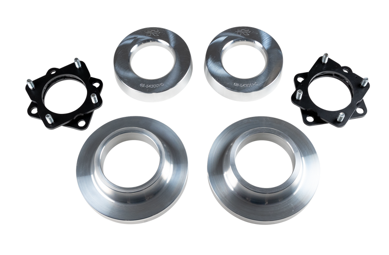 ReadyLIFT SST Lift Kit, full kit on a studio background: two black strut spacers and four aluminum coil spacers on a black-bordered white strip
