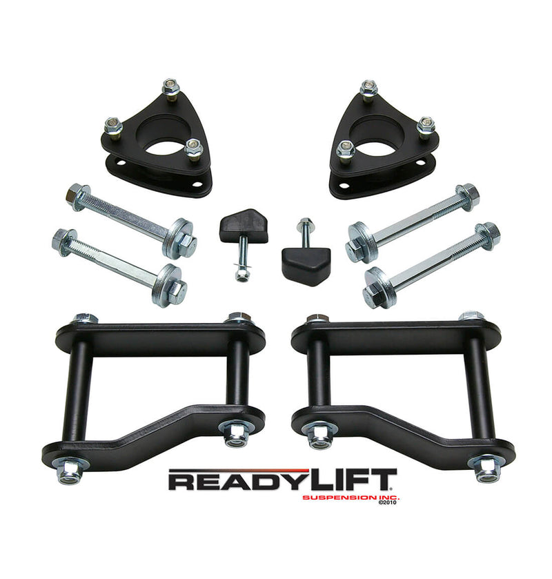 ReadyLIFT SST Lift Kit, full kit on a studio background: two black strut spacers, bolts, bump stops and two black rear lift shackles above a ReadyLIFT logo