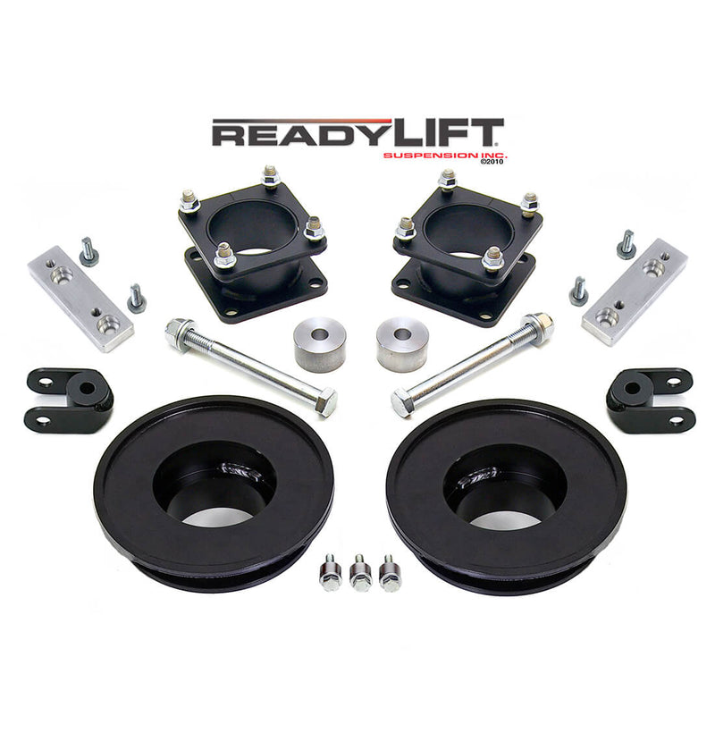 ReadyLIFT SST Lift Kit, full kit on a studio background: two black strut spacers, two black rear coil spacers, aluminum brackets, bolts and shackles under a ReadyLIFT logo