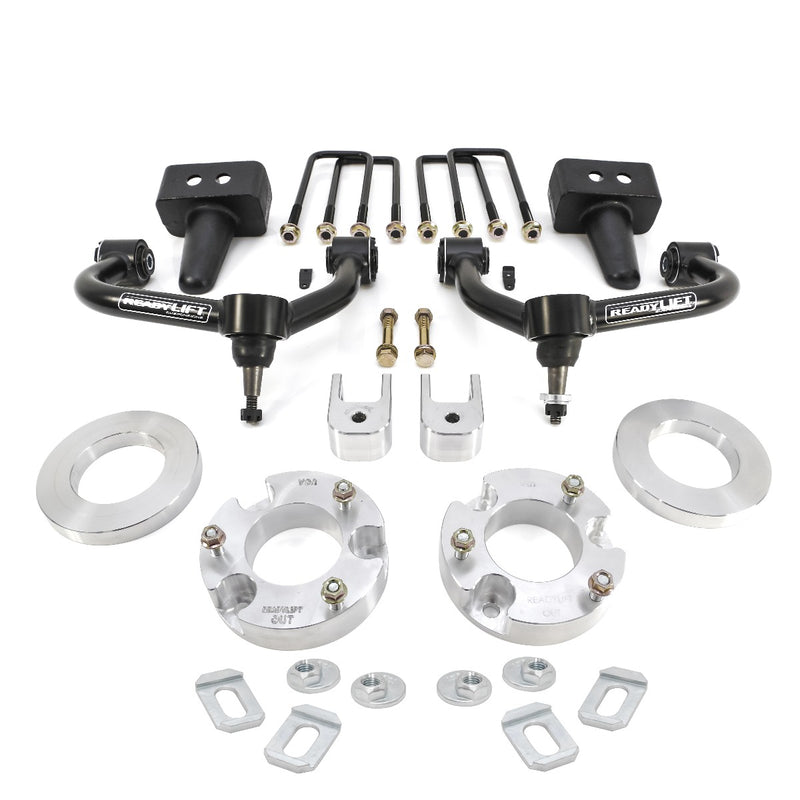 ReadyLIFT SST Lift Kit, full kit on a studio background: two black upper control arms, aluminum strut spacers, tapered rear blocks, U-bolts and hardware on white