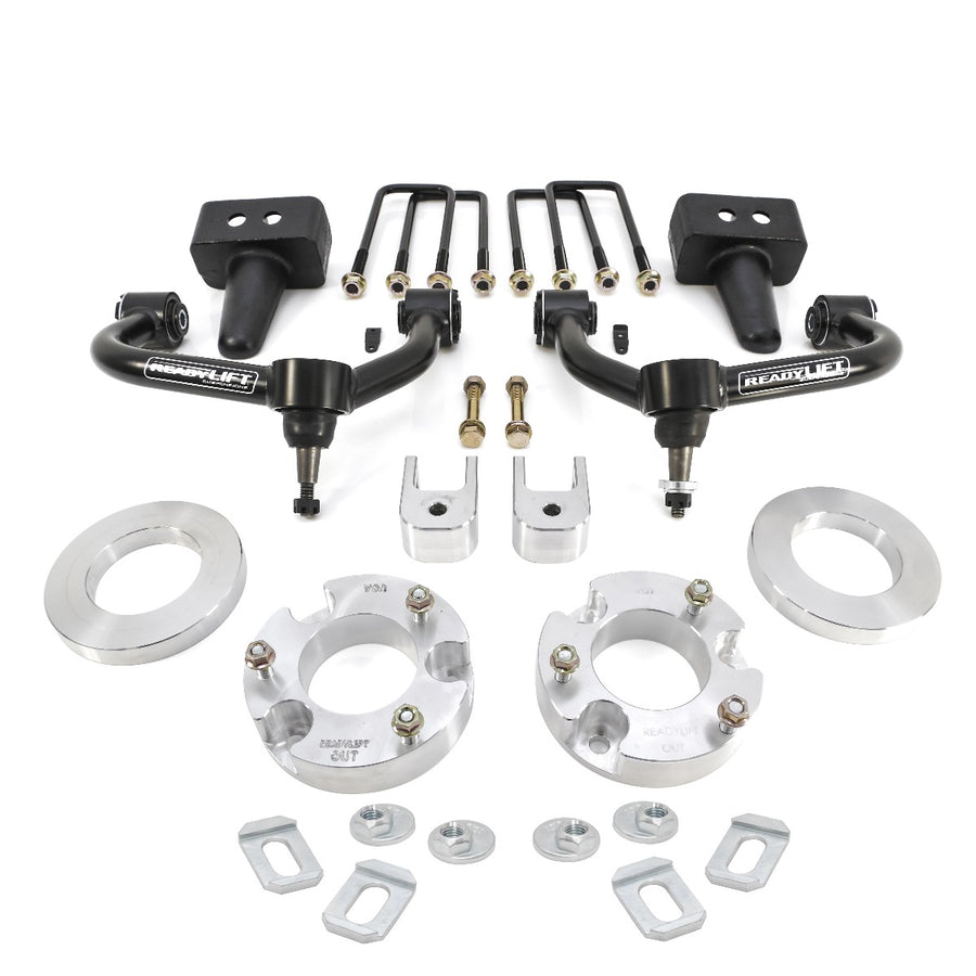 ReadyLIFT SST Lift Kit, full kit on a studio background: two black upper control arms, aluminum strut spacers, tapered rear blocks, U-bolts and hardware on white