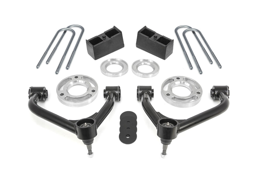 ReadyLIFT SST Lift Kit, full kit on a studio background: two black upper control arms, aluminum strut spacers, rear blocks, zinc U-bolts and bump stop pads on white