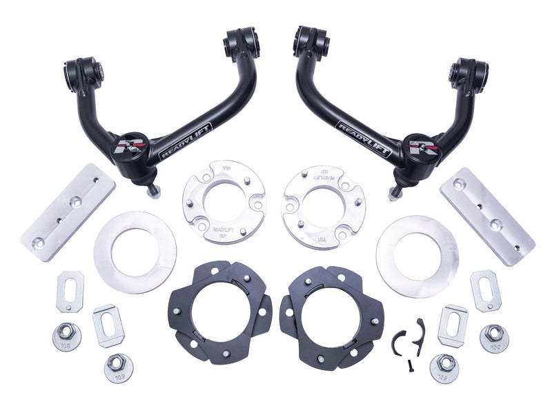 ReadyLIFT SST Lift Kit, full kit on a studio background: two black upper control arms, aluminum strut spacers, black plates, brackets and hardware on white
