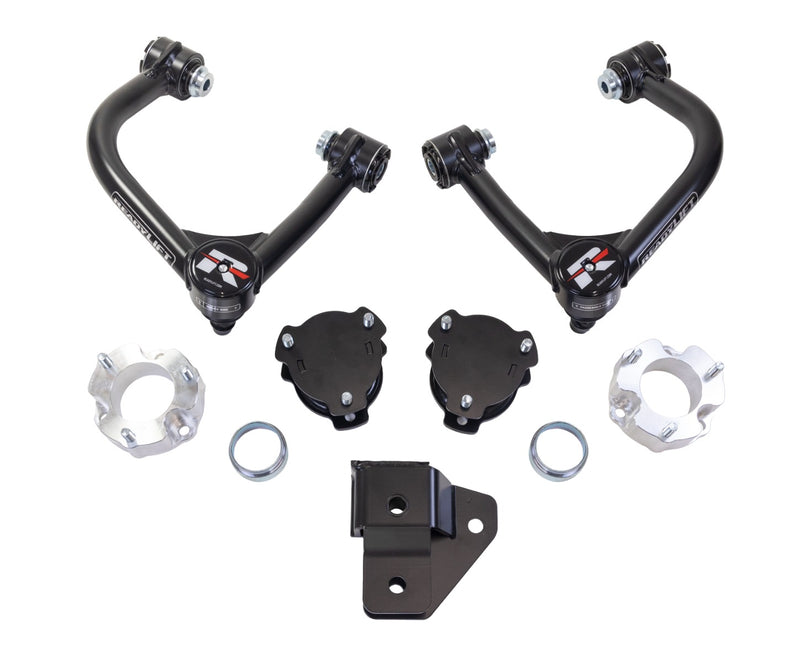ReadyLIFT SST Lift Kit, full kit on a studio background: two black upper control arms, black and aluminum spacers, rings and a bracket on white