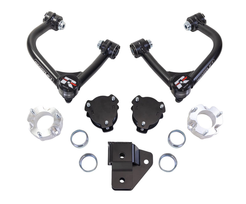 ReadyLIFT SST Lift Kit, full kit on a studio background: two black upper control arms, black and aluminum spacers, rings and a bracket on white