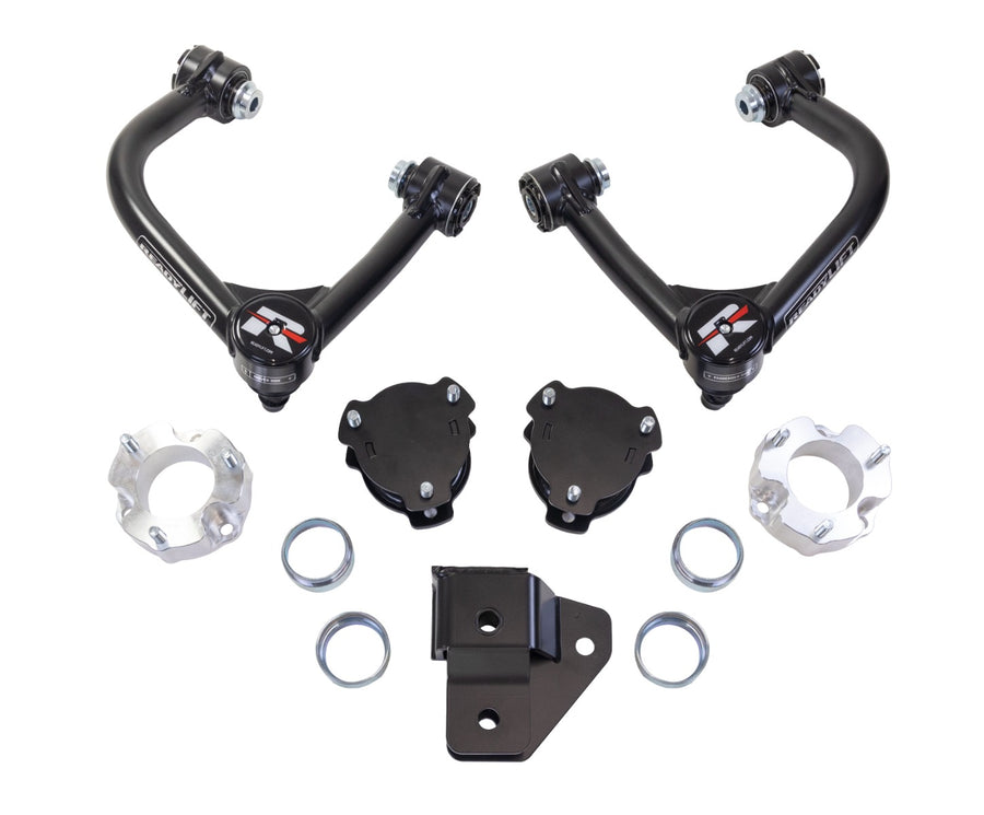 ReadyLIFT SST Lift Kit, full kit on a studio background: two black upper control arms, black and aluminum spacers, rings and a bracket on white