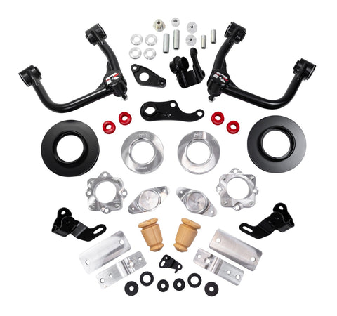 ReadyLIFT SST Lift Kit, full kit on a studio background: two black upper control arms, black and aluminum spacers, aluminum brackets, bump stops, red bushings and hardware on white
