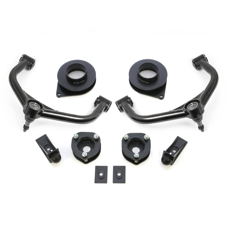 ReadyLIFT SST Lift Kit, full kit on a studio background: two black upper control arms, strut spacers, rear coil spacers, bump stop extensions and plates on white