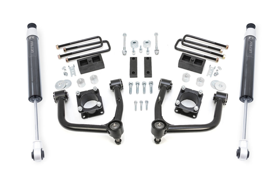 ReadyLIFT SST Lift Kit, full kit on a studio background: two black upper control arms, strut spacers, rear blocks, U-bolts and two gray Falcon rear shocks on white