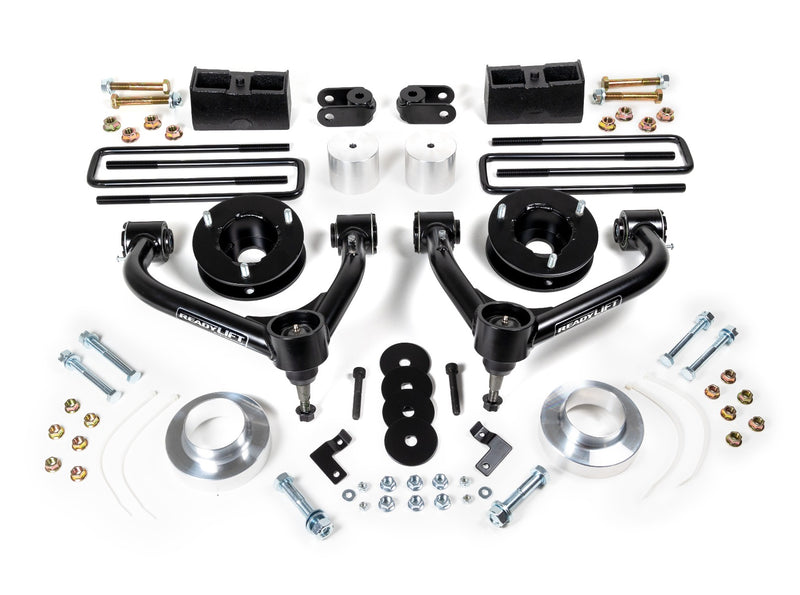 ReadyLIFT SST Lift Kit, full kit on a studio background: two black upper control arms, strut spacers, aluminum spacers, rear blocks, U-bolts and hardware on white