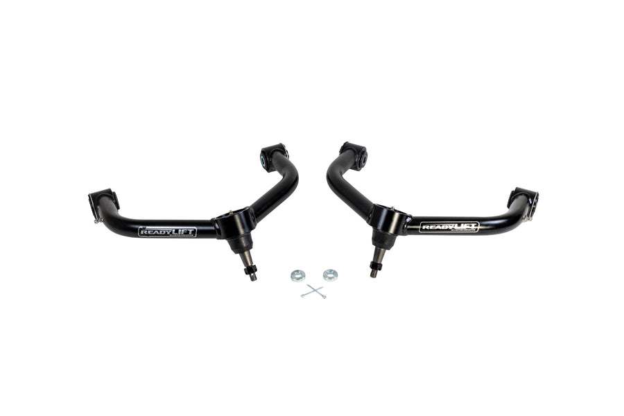 ReadyLIFT SST UCA, full kit on a studio background: A pair of black ReadyLIFT upper control arms with ball joints and small hardware on white