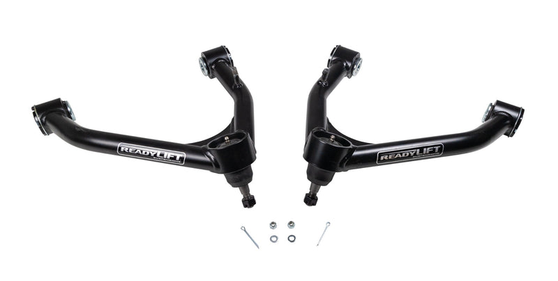 ReadyLIFT SST UCA, full kit on a studio background: A pair of black ReadyLIFT upper control arms with ball joints and cotter pins on white
