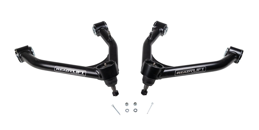 ReadyLIFT SST UCA, full kit on a studio background: A pair of black ReadyLIFT upper control arms with ball joints and cotter pins on white