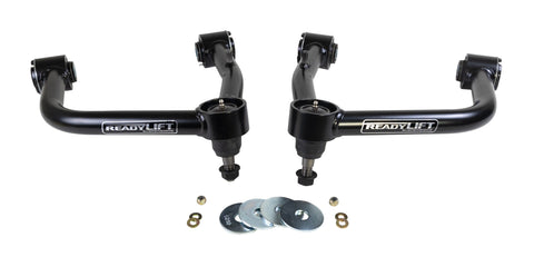 ReadyLIFT SST UCA, full kit on a studio background: A pair of black ReadyLIFT upper control arms with washers and nuts on a white background