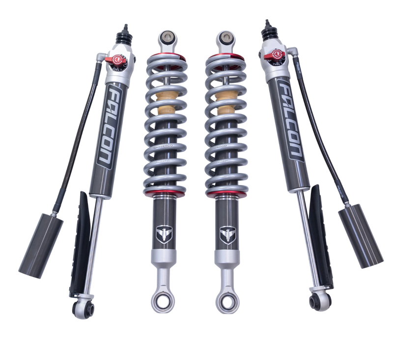 ReadyLIFT SST2.1 Suspension System, full kit on a studio background: two Falcon coilovers and two Falcon rear shocks with remote reservoirs on a black background