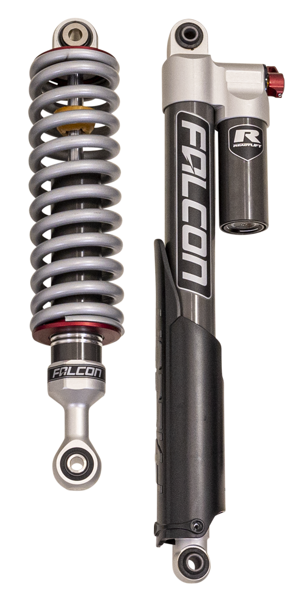 Close-up of the ReadyLIFT Suspension System: A Falcon coilover and a Falcon rear shock with remote reservoir standing on a black-bordered white background