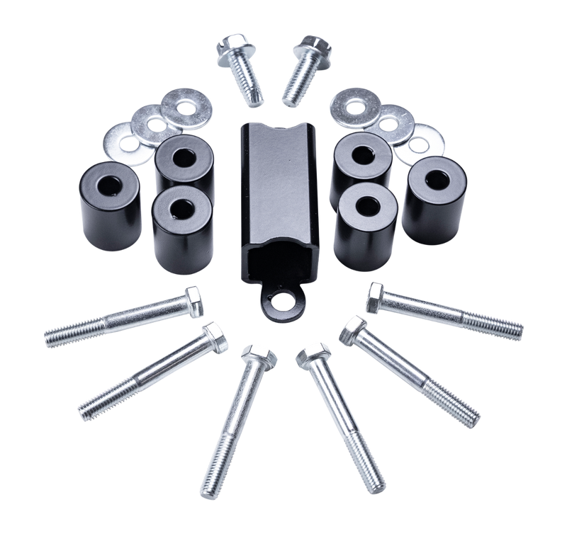 ReadyLIFT TRD Pro Skid Plate Drop Kit, full kit on a studio background: black cylindrical spacers, a black bracket, long bolts and washers on a black background