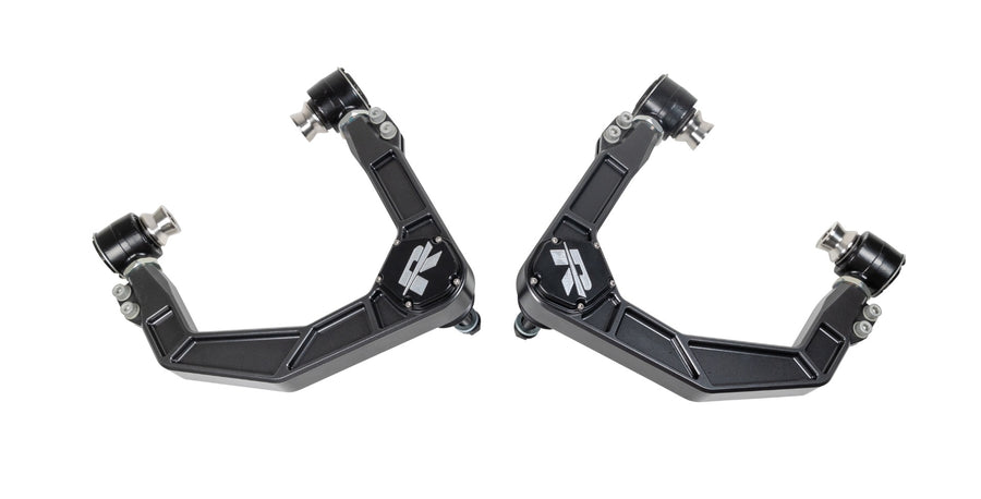 Close-up of the ReadyLIFT Upper Control Arms: A pair of dark gray forged upper control arms with ReadyLIFT R logos on white
