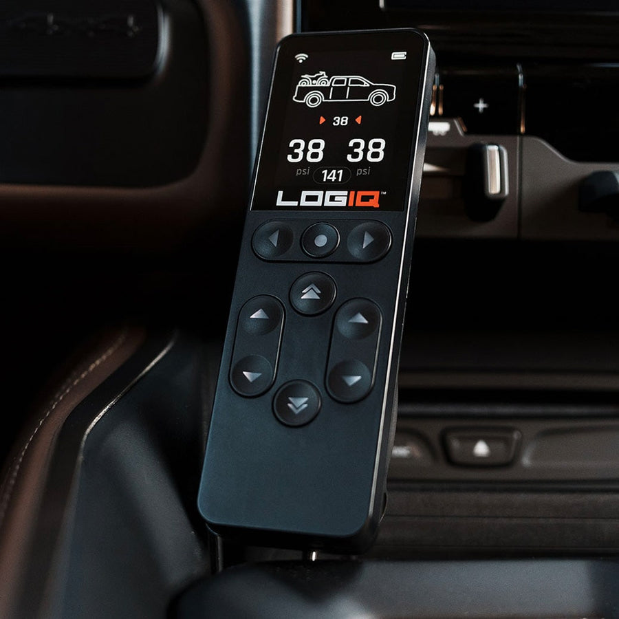 AirIQ Air Management by ReadyLIFT: The LOGIQ AirIQ remote displaying 38 psi readings held in its magnetic dock inside a dark vehicle cab.